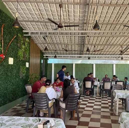 Group of friends sharing a Konkani fish thali dinner at Dolphin House resort restaurant